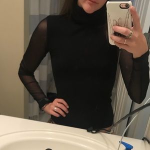 black turtle neck with sheer sleeves